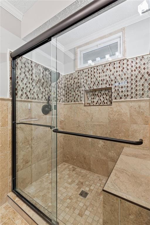 full bath featuring crown molding, a stall shower, and a textured ceiling