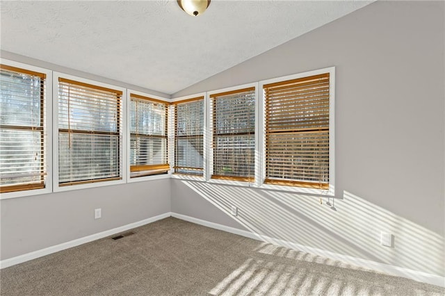 unfurnished sunroom featuring visible vents and lofted ceiling