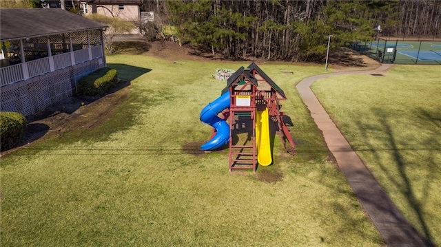 community jungle gym featuring a yard