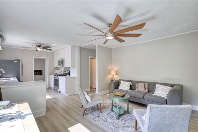 1149 Avondale Ave SE, Atlanta, GA 30312 - living room featuring a ceiling fan, light wood-type flooring, baseboards, and ornamental molding