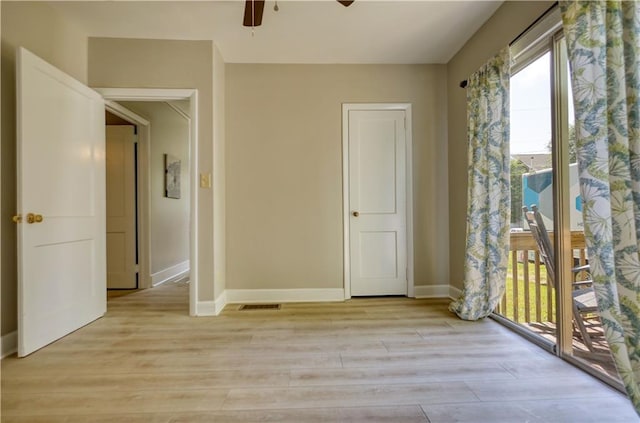 1149 Avondale Ave SE, Atlanta, GA 30312 - unfurnished bedroom with access to outside, light wood-style floors, baseboards, and a ceiling fan