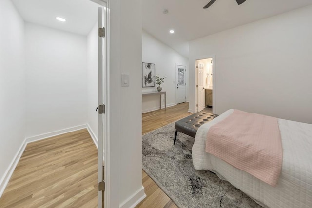 bedroom featuring vaulted ceiling, ceiling fan, ensuite bathroom, and light hardwood / wood-style floors