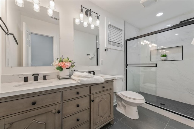 bathroom with an enclosed shower, vanity, tile patterned flooring, and toilet