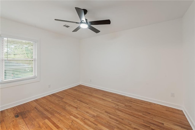 empty room featuring wood-type flooring and ceiling fan