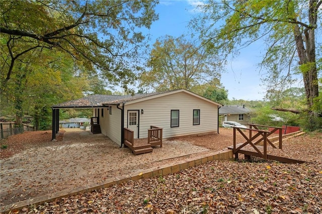 rear view of property featuring a carport