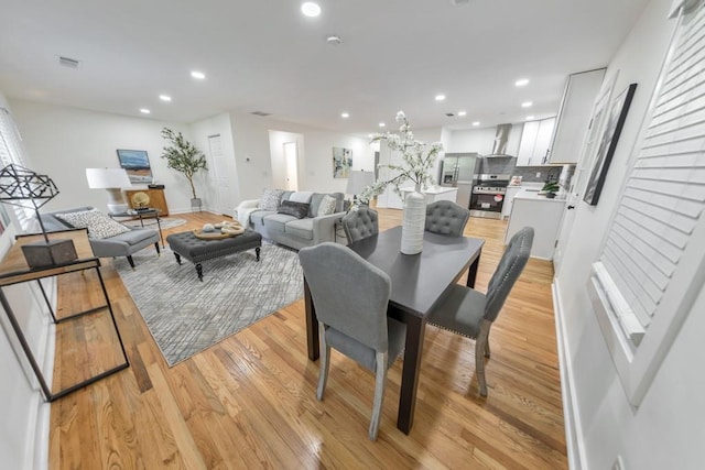 dining space with light wood-type flooring