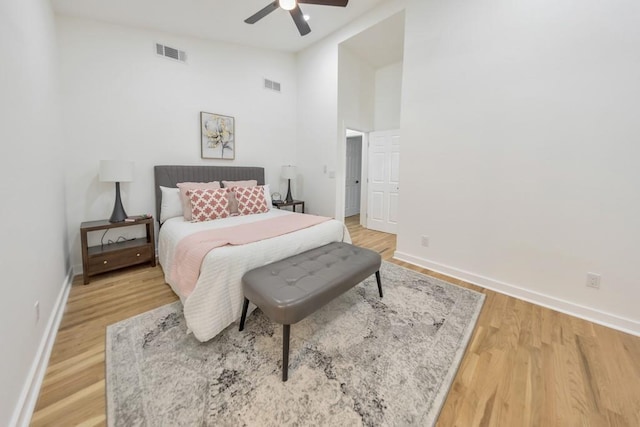 bedroom featuring ceiling fan, high vaulted ceiling, and hardwood / wood-style floors