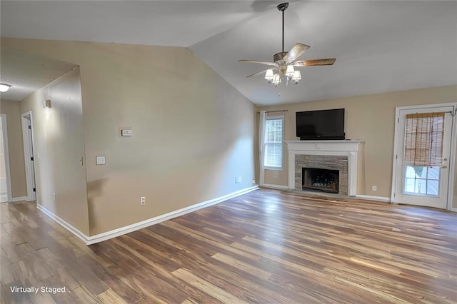 160 Riverbrooke Trl, Covington, GA 30016 - unfurnished living room with vaulted ceiling, wood finished floors, baseboards, a fireplace, and ceiling fan