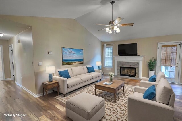 160 Riverbrooke Trl, Covington, GA 30016 - living room with wood finished floors, vaulted ceiling, baseboards, a fireplace, and a ceiling fan