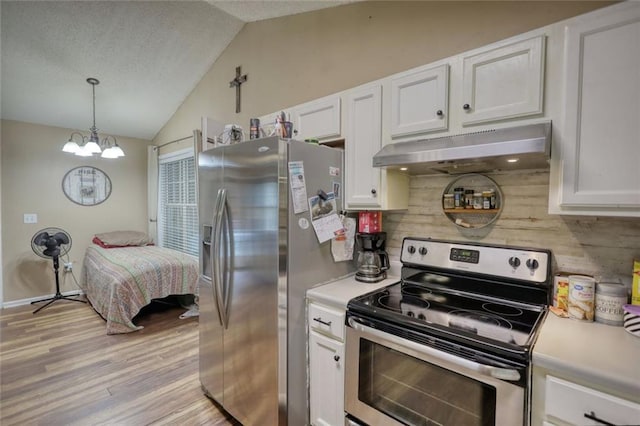 160 Riverbrooke Trl, Covington, GA 30016 - kitchen with appliances with stainless steel finishes, under cabinet range hood, vaulted ceiling, white cabinetry, and backsplash