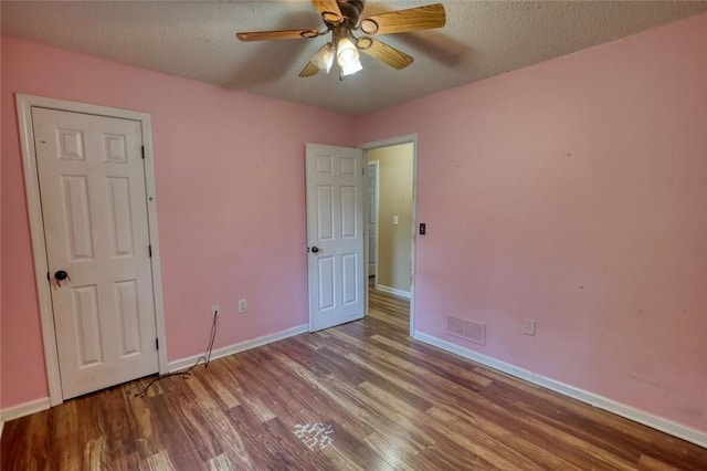 160 Riverbrooke Trl, Covington, GA 30016 - unfurnished bedroom featuring wood finished floors, baseboards, a textured ceiling, and ceiling fan