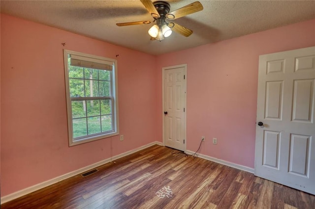 160 Riverbrooke Trl, Covington, GA 30016 - unfurnished bedroom featuring wood finished floors, baseboards, a textured ceiling, and a ceiling fan