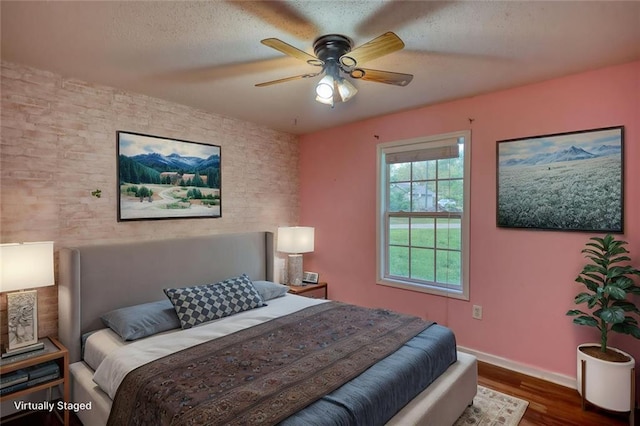 160 Riverbrooke Trl, Covington, GA 30016 - bedroom with wood finished floors, baseboards, a textured ceiling, and a ceiling fan