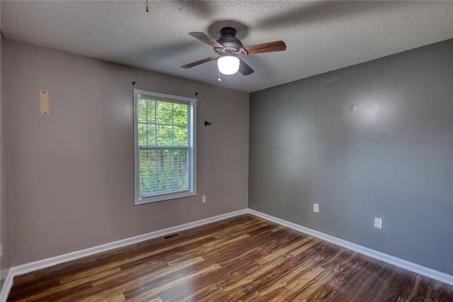 160 Riverbrooke Trl, Covington, GA 30016 - spare room with dark wood finished floors, a textured ceiling, baseboards, and ceiling fan