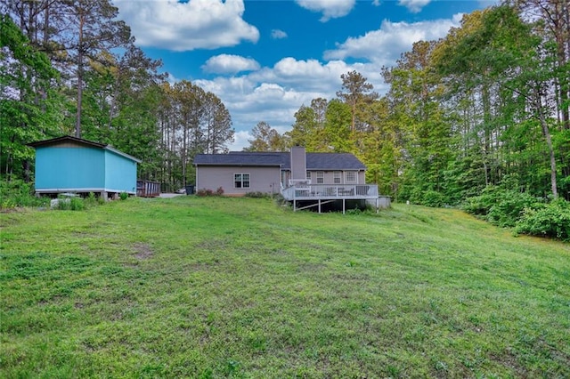 160 Riverbrooke Trl, Covington, GA 30016 - rear view of house featuring a deck, a lawn, a chimney, and an outdoor structure