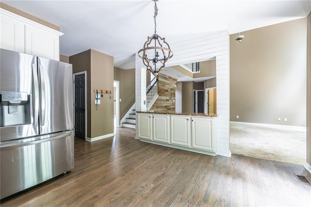 kitchen featuring stainless steel fridge with ice dispenser, a chandelier, baseboards, and white cabinets