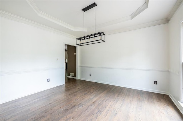 unfurnished dining area with a raised ceiling, dark wood-style floors, ornamental molding, and baseboards