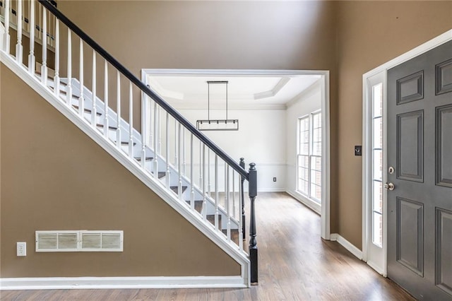 entryway featuring wood finished floors, stairway, and baseboards