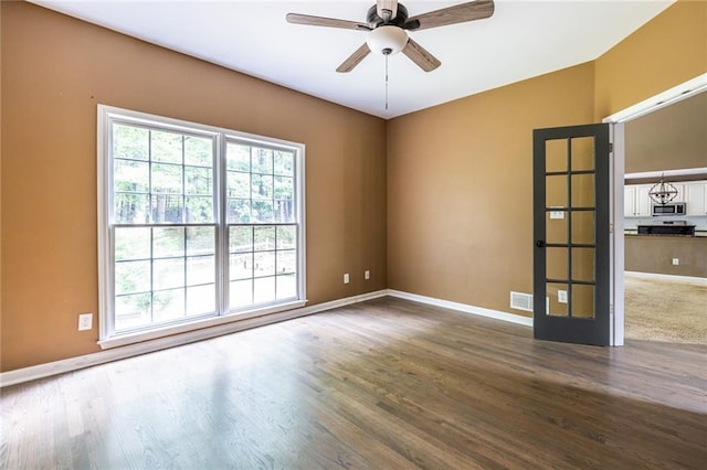 spare room with plenty of natural light, baseboards, and ceiling fan