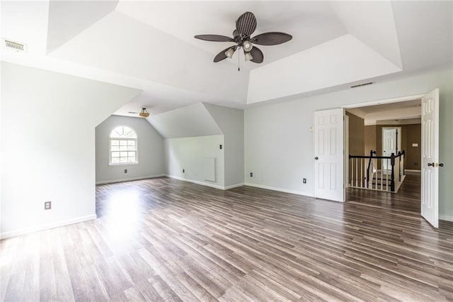 additional living space featuring wood finished floors, a ceiling fan, baseboards, and vaulted ceiling
