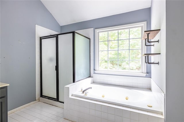 bathroom featuring a stall shower, tile patterned flooring, lofted ceiling, a jetted tub, and vanity