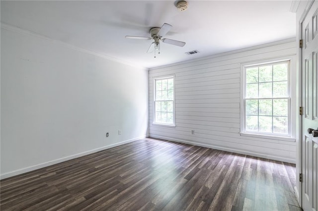 unfurnished room with dark wood-style flooring, ceiling fan, baseboards, ornamental molding, and a smoke detector