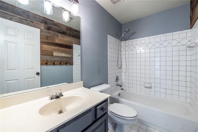 bathroom with toilet, wood walls, shower / bathtub combination, vanity, and tile patterned flooring