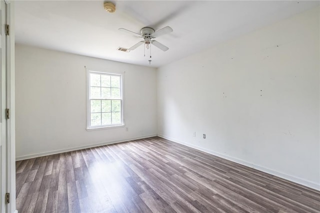 empty room with wood finished floors, ceiling fan, and baseboards