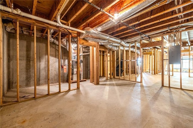 basement featuring heating unit and electric panel