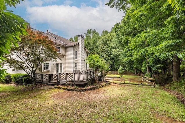 view of grassy yard featuring a wooden deck