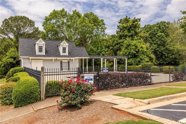view of front of property with fence, uncovered parking, and a shingled roof