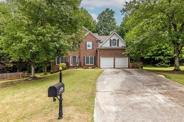 traditional-style house with driveway, brick siding, and an attached garage