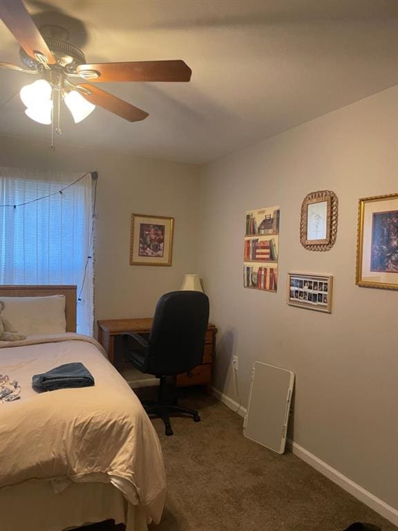 carpeted bedroom with a ceiling fan and baseboards