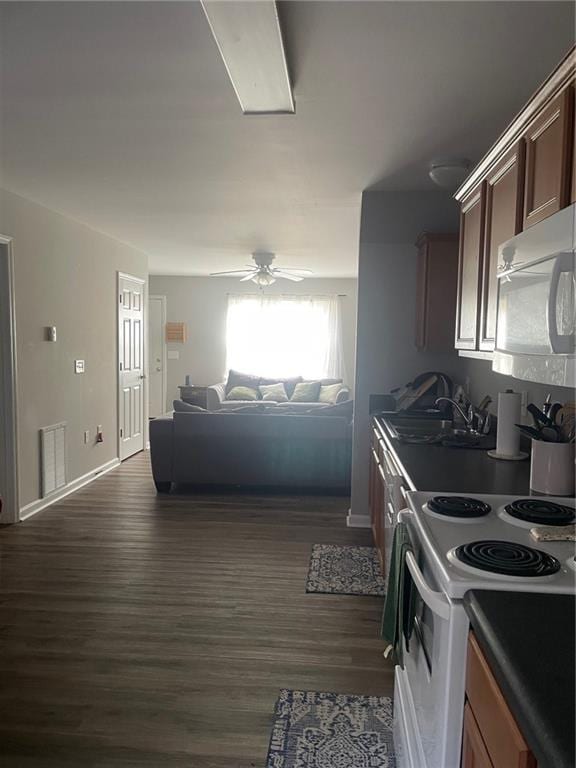 kitchen featuring white range with electric stovetop, visible vents, dark wood finished floors, a ceiling fan, and a sink