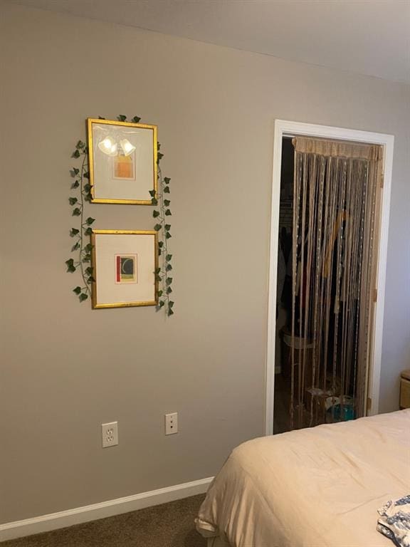 bedroom featuring carpet flooring and baseboards