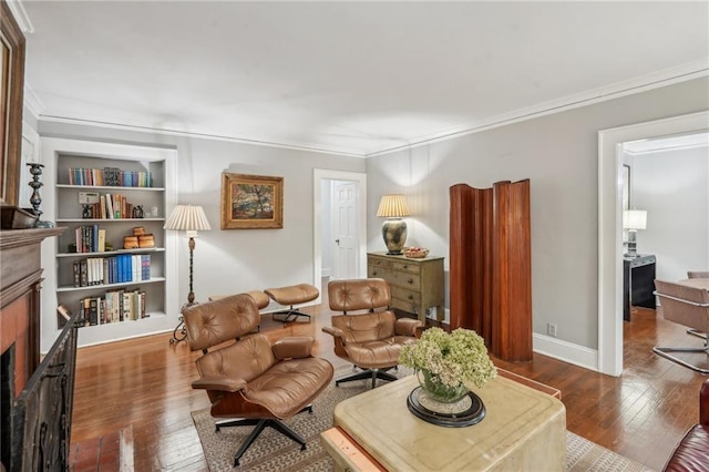25 Standish Ave NW, Atlanta, GA 30309 - living area with a fireplace, hardwood / wood-style flooring, ornamental molding, built in shelves, and baseboards