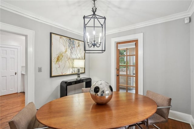 25 Standish Ave NW, Atlanta, GA 30309 - dining space with wood finished floors, ornamental molding, a chandelier, and baseboards