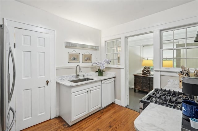 25 Standish Ave NW, Atlanta, GA 30309 - kitchen featuring a sink, dishwasher, stainless steel fridge, wood finished floors, and gas range oven
