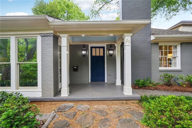 25 Standish Ave NW, Atlanta, GA 30309 - entrance to property featuring brick siding, a chimney, and covered porch
