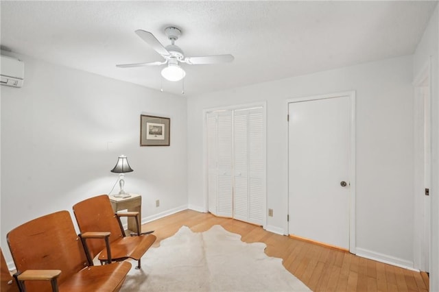 25 Standish Ave NW, Atlanta, GA 30309 - living area featuring a wall mounted air conditioner, wood finished floors, baseboards, and ceiling fan