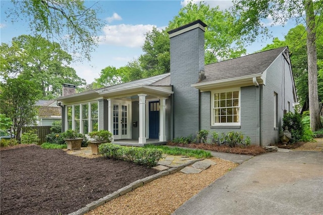 25 Standish Ave NW, Atlanta, GA 30309 - view of front of house featuring a chimney, french doors, brick siding, and fence
