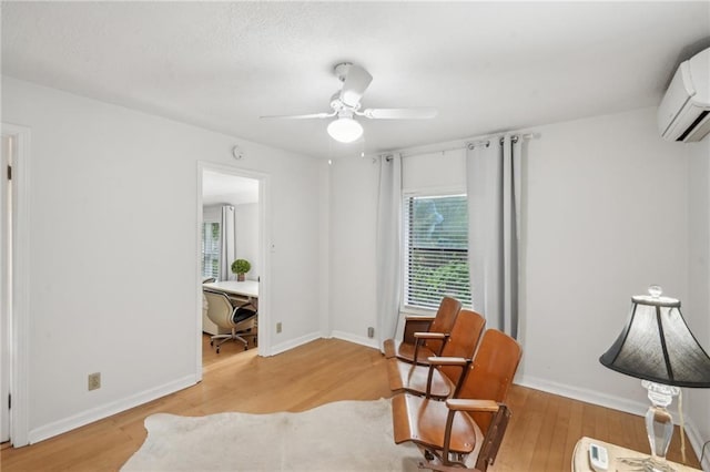 25 Standish Ave NW, Atlanta, GA 30309 - sitting room with an AC wall unit, light wood-style floors, an office area, a ceiling fan, and baseboards