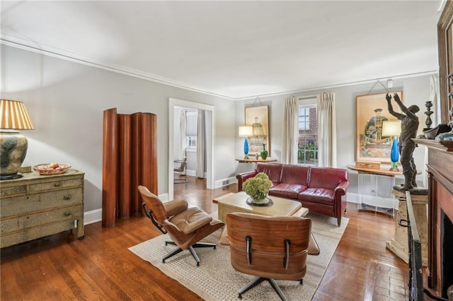 25 Standish Ave NW, Atlanta, GA 30309 - living area featuring a fireplace, wood finished floors, crown molding, and baseboards