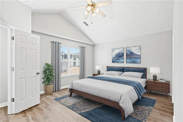 bedroom featuring light hardwood / wood-style floors, high vaulted ceiling, and ceiling fan