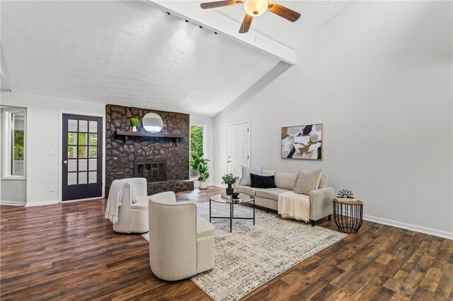 3833 Paddington Trl, Rex, GA 30273 - living room with wood finished floors, a stone fireplace, ceiling fan, a textured ceiling, and beamed ceiling