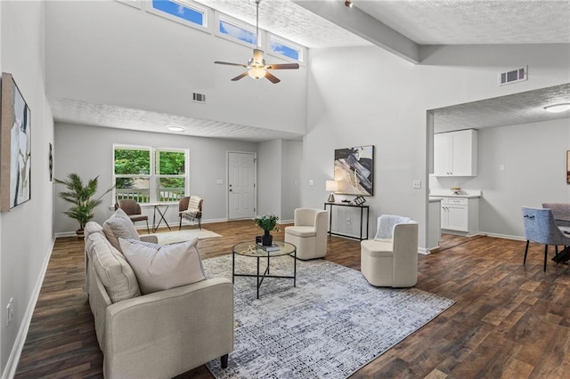 3833 Paddington Trl, Rex, GA 30273 - living room with high vaulted ceiling, dark wood-style flooring, a ceiling fan, and a textured ceiling