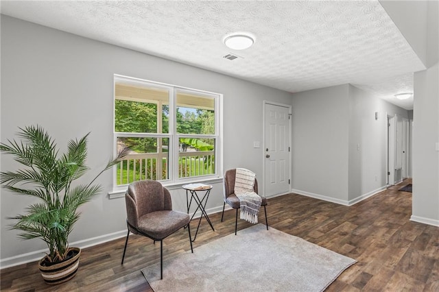 3833 Paddington Trl, Rex, GA 30273 - living area featuring a textured ceiling and wood finished floors