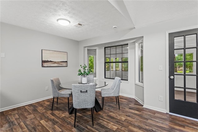3833 Paddington Trl, Rex, GA 30273 - dining room featuring healthy amount of natural light, dark wood finished floors, and a textured ceiling