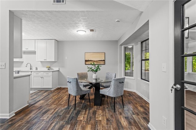 3833 Paddington Trl, Rex, GA 30273 - dining room featuring dark wood finished floors and a textured ceiling