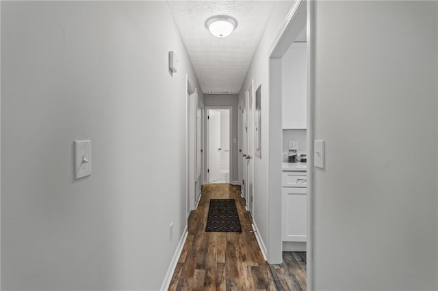 3833 Paddington Trl, Rex, GA 30273 - hallway featuring a textured ceiling and dark wood finished floors
